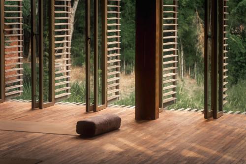 a wooden object on a wooden floor in front of a window at Balquisse Heritage Hotel in Jimbaran