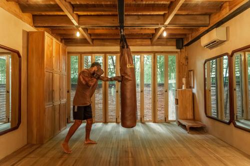 a man standing in a room with a punching bag at Balquisse Heritage Hotel in Jimbaran