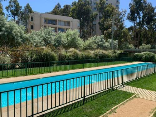 a swimming pool with a fence next to a building at Refugio Alto Mirasol in Mirasol
