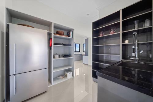 a kitchen with a stainless steel refrigerator and a sink at Panorama Farm - 3BD Wilderness Retreat in Bald Knob
