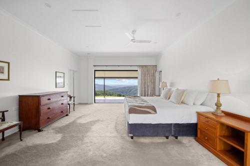 a bedroom with a bed and a dresser and a window at Panorama Farm - 3BD Wilderness Retreat in Bald Knob