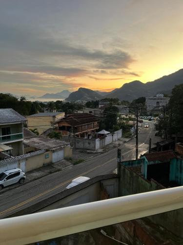 a view of a city with a road and mountains at My House Muriqui in Mangaratiba