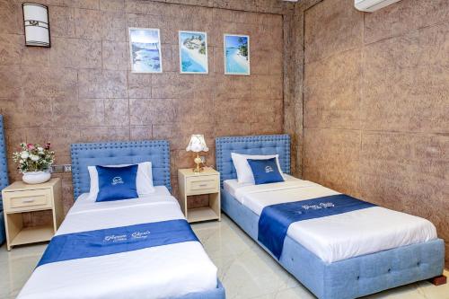 two beds sitting next to each other in a room at Green Oasis Nha Trang Resort in Nha Trang