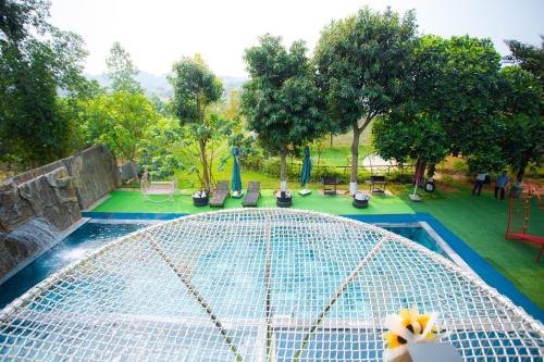 a view of a swimming pool in a park at King Bavi Resort in Ba Vì