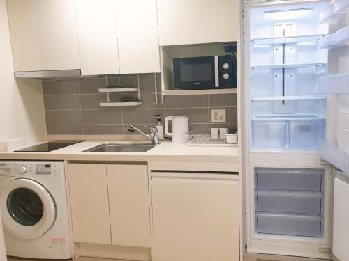 a small kitchen with a sink and a refrigerator at 2519#Gangnam Urban Vogue Suites #Top-rated Unit # All-New Furniture & Peaceful Vibe#Sinnonhyeon 1min in Seoul