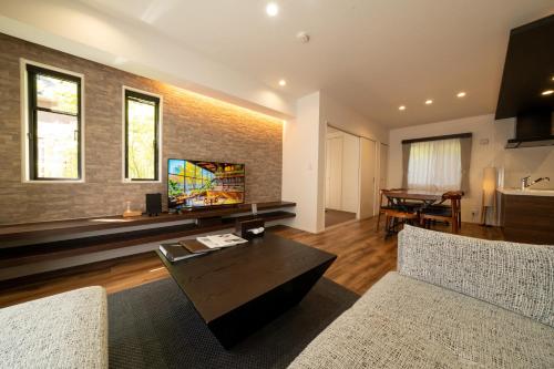 a living room with a couch and a table at 梅の由 離れUMENOYU-HANARE 120m2 in Dazaifu