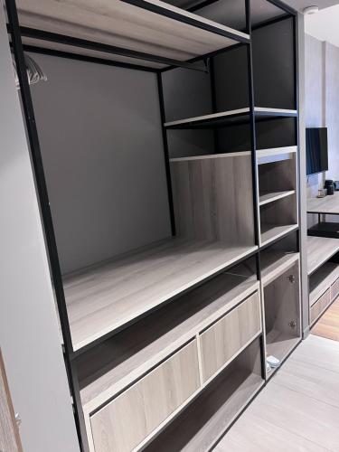 a closet with black and wooden shelves in a room at 秐朗文旅AKA Hotel in Taipei
