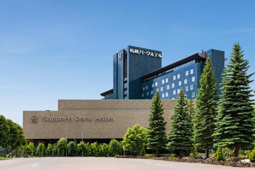 a santa clara bean hotel with trees in front of it at Sapporo Park Hotel in Sapporo