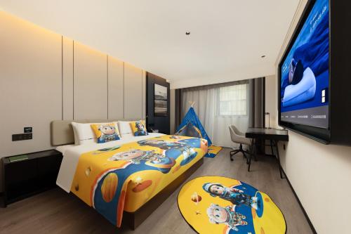 a bedroom with a bed and a flat screen tv at Atour Hotel People's Square Metro Station Shanghai in Shanghai