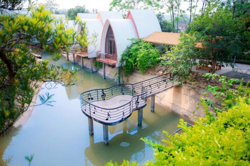an overhead view of a bridge in a body of water at King Bavi Resort in Ba Vì