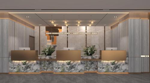 a lobby of a hotel with a chandelier at HARRIS Hotel & Suites Nagoya Batam in Nagoya