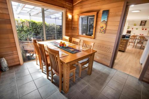 a dining room with a wooden table and chairs at Dun Ri in Paynesville