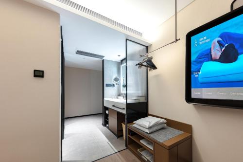 a room with a projection screen on the wall at Atour Hotel People's Square Metro Station Shanghai in Shanghai
