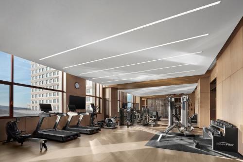 a gym with cardio equipment in a building at Wanda Jin Hotel Ordos in Ordos