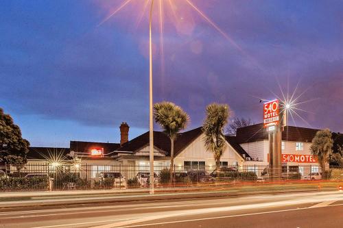 a building with a sign on the side of a street at 540 on Great South Motel in Auckland