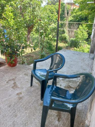 a blue chair sitting on top of a patio at Cozy Riverside Apartment in Këlcyrë
