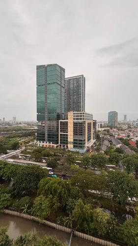 a city skyline with tall buildings and a river at apartement cempaka mas in Jakarta