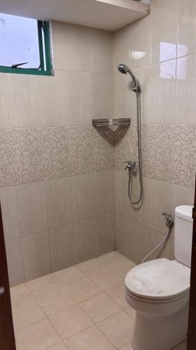 a bathroom with a toilet and a shower at apartement cempaka mas in Jakarta