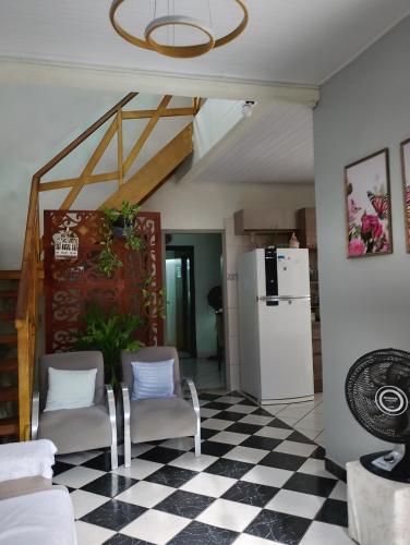 a living room with a black and white checkered floor at Pousada flores in Porto Velho