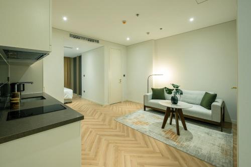 a living room with a couch and a table at Epic Tower Swiss-Belresidences Hanoi in Hanoi