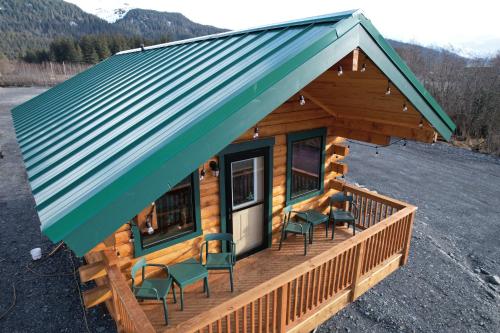 a log cabin with chairs on the porch at Sockeye Cabin in Seward