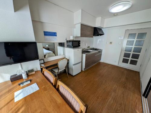 a living room with a kitchen and a dining room at To-Be in Nagoya
