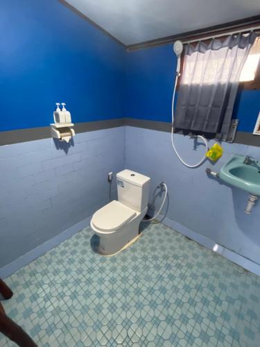 a bathroom with a toilet and a sink at Batur OASE in Kubupenlokan