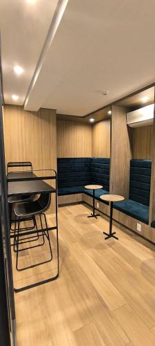 a waiting room with two tables and a piano at Studio espaçoso- Vl Clementino in Sao Paulo