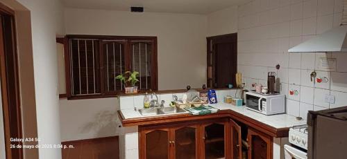 a kitchen with a sink and a microwave at Departamento Peru y Borges in Santiago del Estero