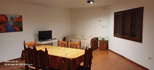 a living room with a table and a dining room at Departamento Peru y Borges in Santiago del Estero