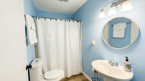 a bathroom with a toilet and a sink and a mirror at Blue Casita in Woodville