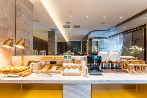 a buffet at a hotel with food on a counter at Atour Hotel Suzhou Mudu Ancient Town in Suzhou