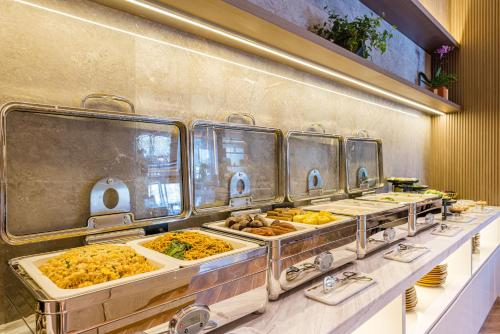 a buffet line with many different types of food at Atour Hotel Suzhou Mudu Ancient Town in Suzhou
