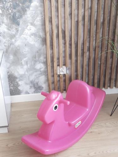 a pink elephant chair sitting in a room at Grunwaldzka 65 Elbląg in Elblag
