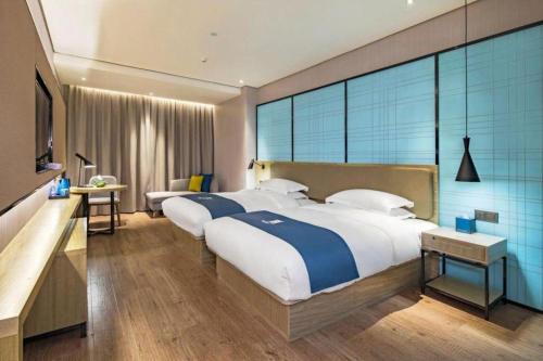 Ένα ή περισσότερα κρεβάτια σε δωμάτιο στο Echarm Hotel Guilin Railway Station the MixC