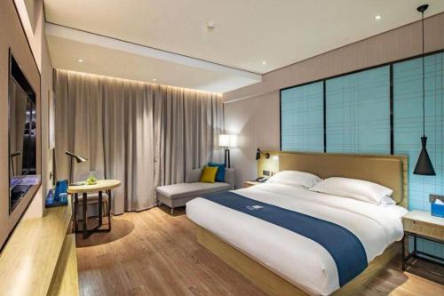 Ένα ή περισσότερα κρεβάτια σε δωμάτιο στο Echarm Hotel Guilin Railway Station the MixC
