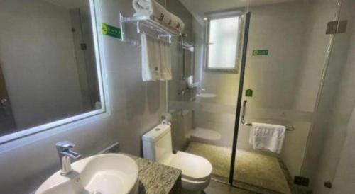 a bathroom with a sink and a toilet and a shower at Borrman Hotel Huizhou West Lake Shuidong Street in Huizhou