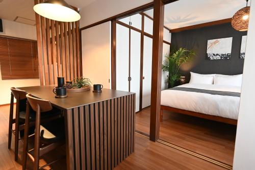 a hotel room with a bed and a desk and a table at Cocoro404 in Kichijōji