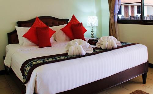 a bedroom with a large bed with towels on it at Namkhong Riverside in Chiang Khong
