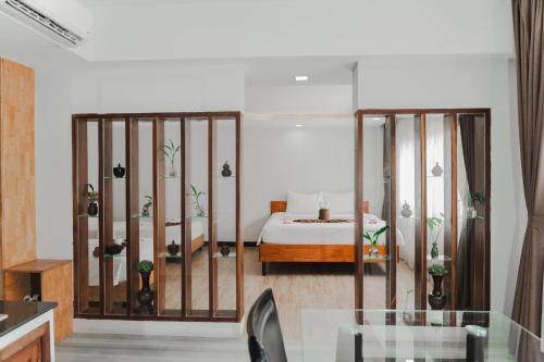 a bedroom with a bed and a glass table at SIEM REAP RIVER VIEW Residence in Siem Reap