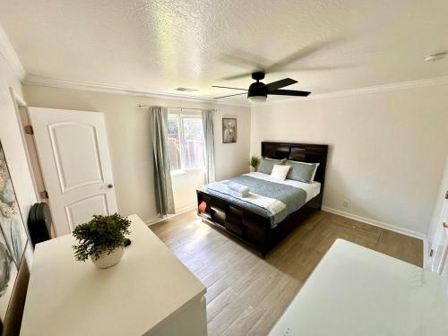 a living room with a bed and a ceiling fan at Intern Choice Cozy 2B2B House nearby Apple Park in Santa Clara