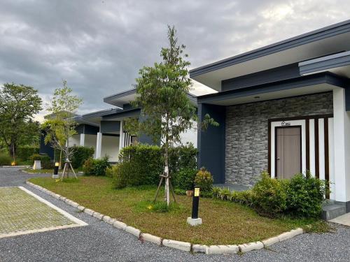 a building with a tree in front of it at Blue Moon Boutique Resort in Sichon