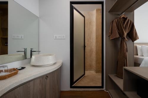 a bathroom with a mirror and a sink at SIEM REAP RIVER VIEW Residence in Siem Reap