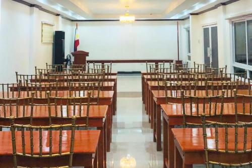 a lecture hall with rows of tables and chairs at SANJH Island Hotel powered by Cocotel in Roxas