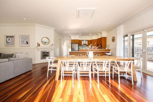 a dining room and living room with a table and chairs at Maori in Rye walk to the beach and shops in minutes in Rye