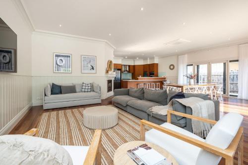 a living room with a couch and a table at Maori in Rye walk to the beach and shops in minutes in Rye