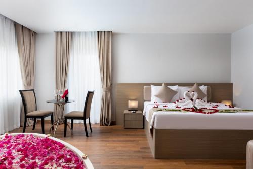 a hotel room with a bed with flowers on it at SIEM REAP RIVER VIEW Residence in Siem Reap