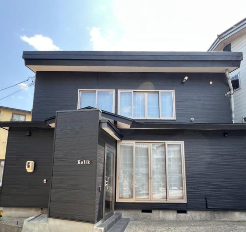 a black house with the front of it at Kalik House in Nozawa Onsen