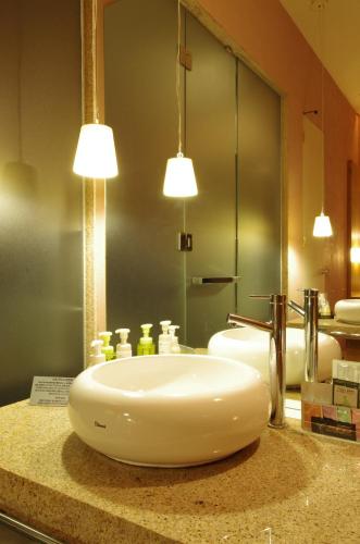 a bathroom with a sink and a mirror at Blue Hotel NAGI-Adult Only in Otaru