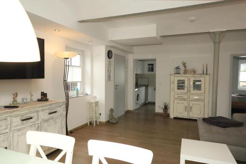 a kitchen and living room with a table and chairs at Gut Kuhfs in Großzössen